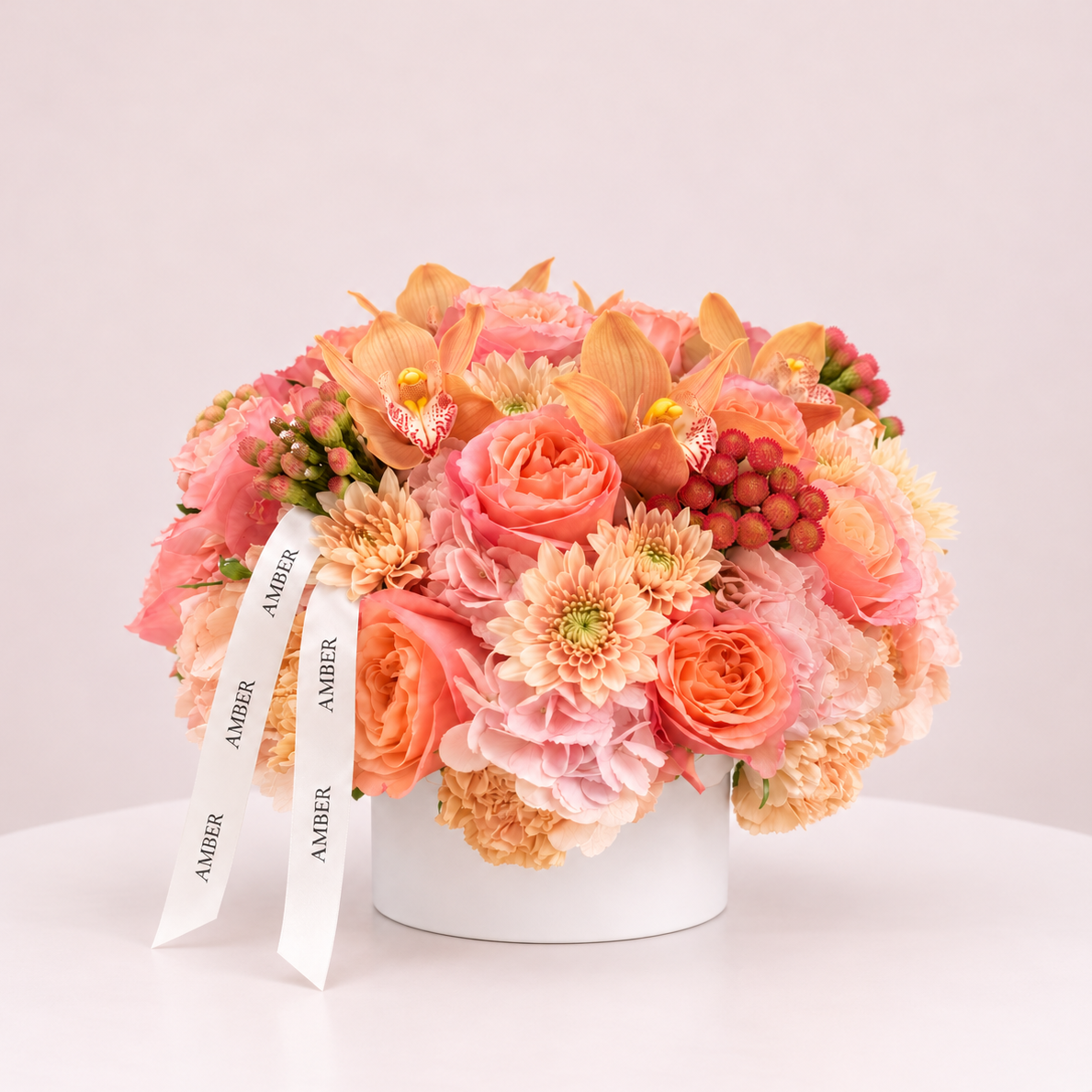 Peach orchid and blush rose fall flower arrangement with cream chrysanthemums by Amber Flowers